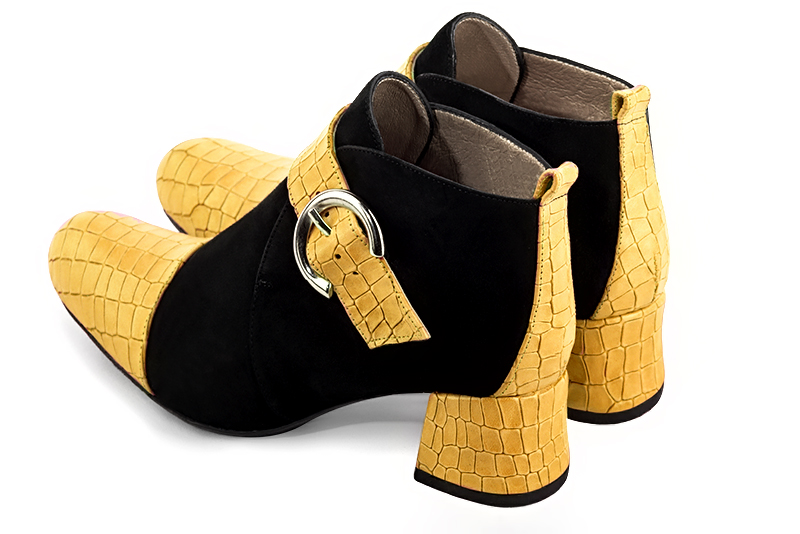 Mustard yellow and matt black women's ankle boots with buckles at the front. Round toe. Low flare heels. Rear view - Florence KOOIJMAN